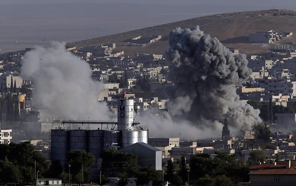 Smoke rises following an airstrike by the US-led coalition aircrafts, during fighting between Syrian Kurds and the militants of Islamic State group, as seen from the outskirts.