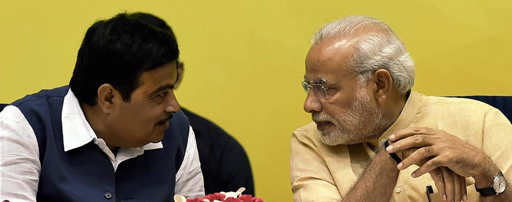 Prime Minister Narendra Modi talking to Union Minister for Rural Development Nitin Gadkari during the launch of Saansad Adarsh Gram Yojana (SAGY) in New Delhi.