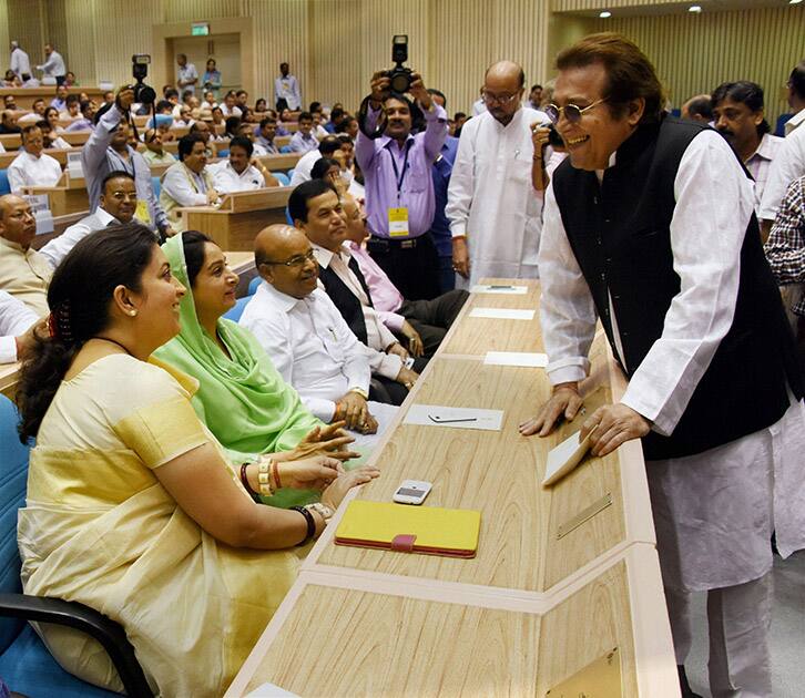 BJP MP Vinod Khanna talking to Union ministers Smriti Irani and Harsimrat Kaur during the launch of Saansad Adarsh Gram Yojana (SAGY) in New Delhi.