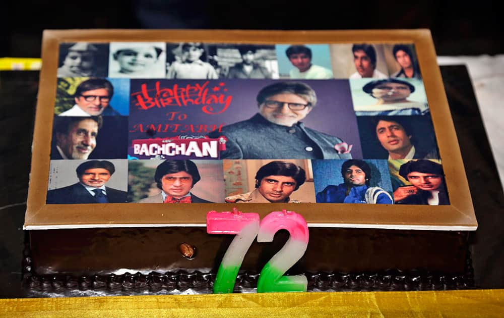 Candles are placed on a cake with a collage of photographs of Indian Bollywood actor Amitabh Bachchan during celebrations on his 72nd birth anniversary in Kolkata.