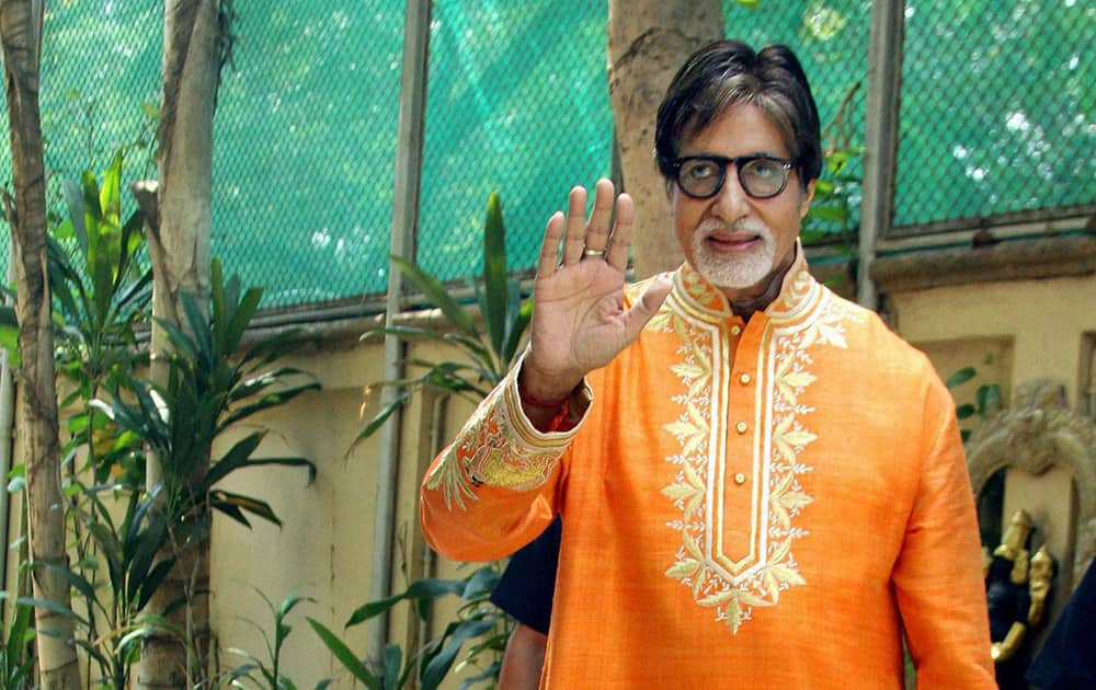 Bollywood mega star Amitabh Bachchan gestures while celebrating his 72nd birthday with the media at his office Janak in Mumbai.