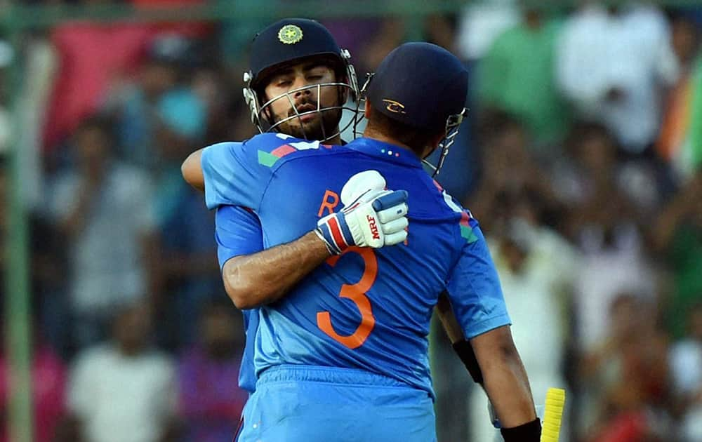 Indias Virat Kohli and Suresh Raina during the 2nd ODI cricket match against West Indies in New Delhi.