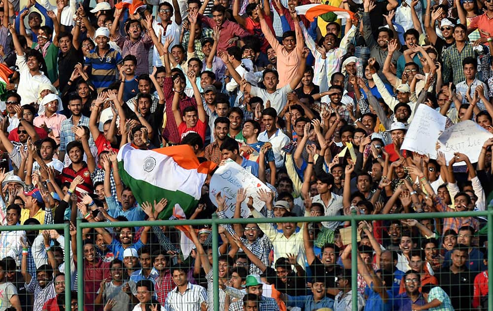 Indian supporters cheer during the 2nd ODI cricket match against West Indies in New Delhi.