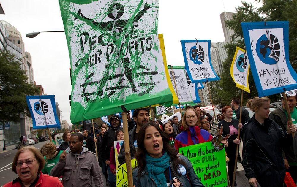 Demonstrators protest outside of the International Monetary Fund (IMF) building during the World Bank Group-International Monetary Fund Annual meeting in Washington.