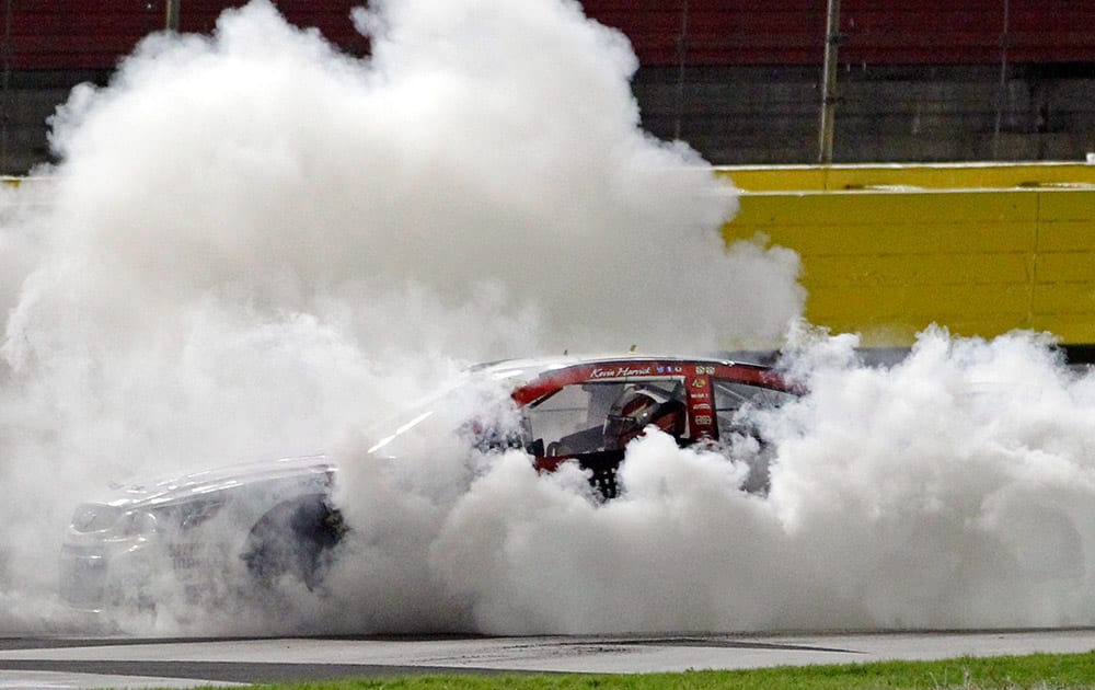 Kevin Harvick performs a burnout after winning the NASCAR Sprint Cup series Bank of America 500 auto race at Charlotte Motor Speedway in Concord, N.C.