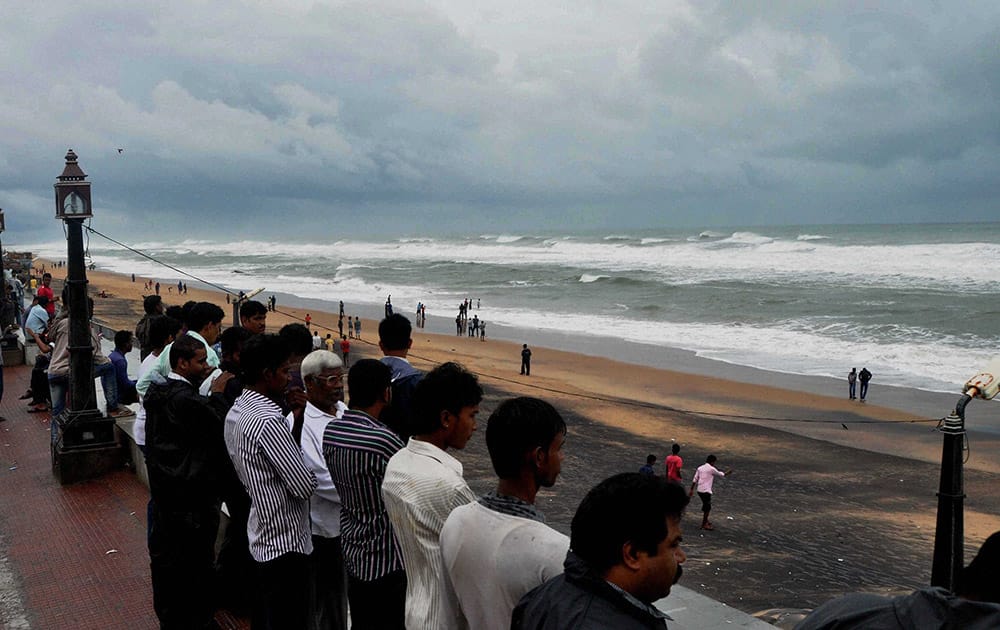 Onlookers looking at Sea tide at Gopalpur beach on the eve of Cyclone Hudhud hits land on Saturday. As per IMD bulletin , Hudhud will hit at Vishakhapatnam on Sunday noon.