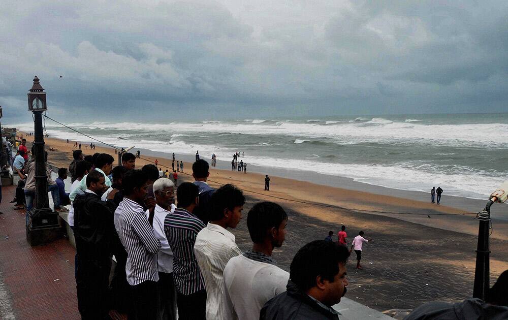 Onlookers looking at Sea tide at Gopalpur beach on the eve of Cyclone Hudhud hits land on Saturday. As per IMD bulletin , Hudhud will hit at Vishakhapatnam.