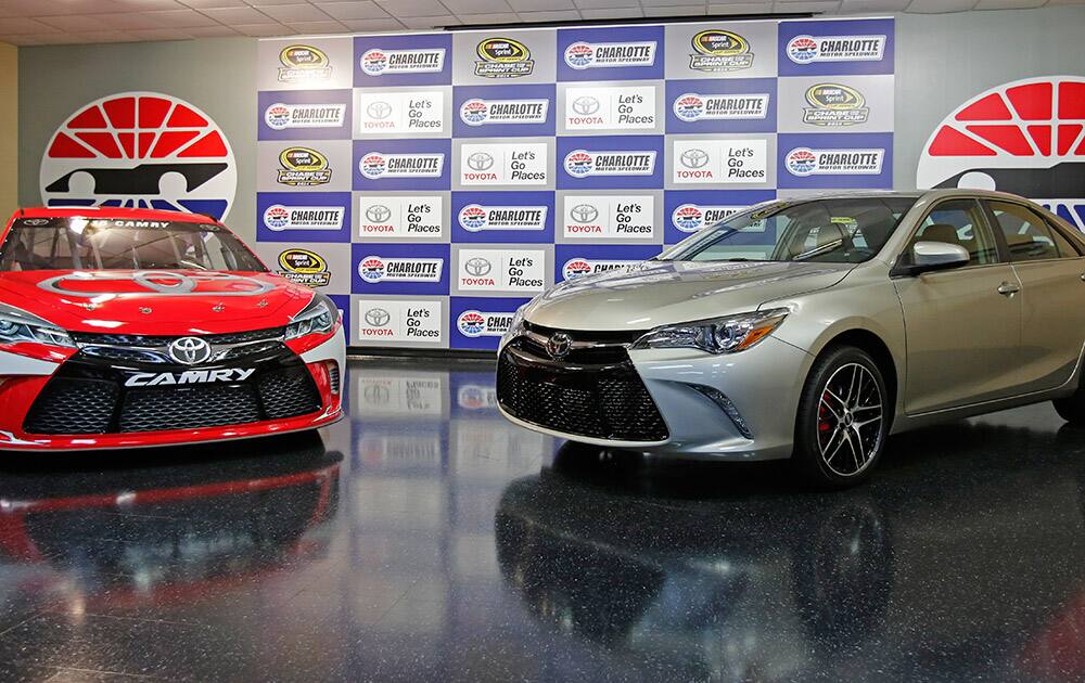 A 2015 Toyota Camry race car, left, is shown with a street version of the 2015 Camry during a news conference before the NASCAR Sprint Cup series Bank of America 500 auto race at Charlotte Motor Speedway in Concord, N.C.