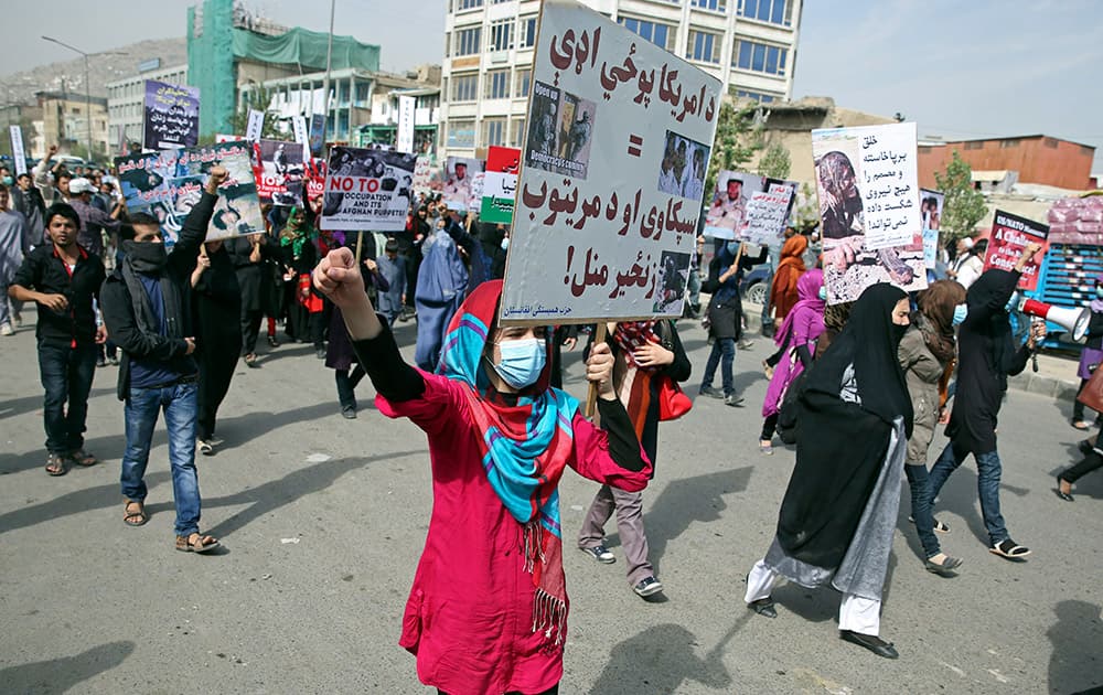 Members of the Solidarity Party of Afghanistan (SPA) shout slogans and wave banners against the presence of U. S. and NATO troops in their country and against the militant Islamic State group, in Kabul, Afghanistan.