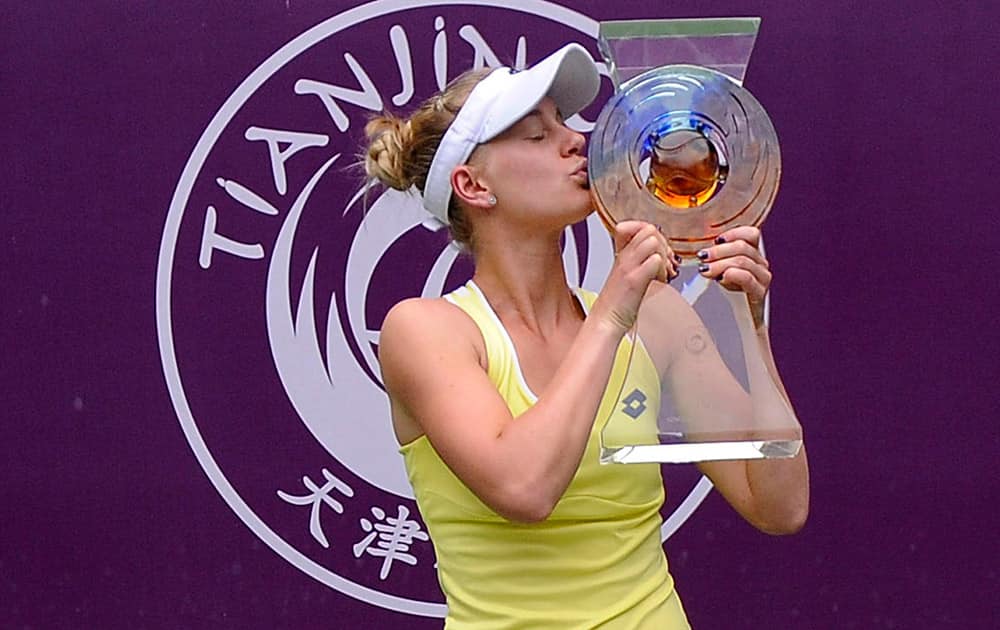 Alison Riske of the United States kisses her trophy after defeating Belinda Bencic of Switzerland for the women's singles final at the Tianjin Open tennis tournament in Tianjin, northern China.