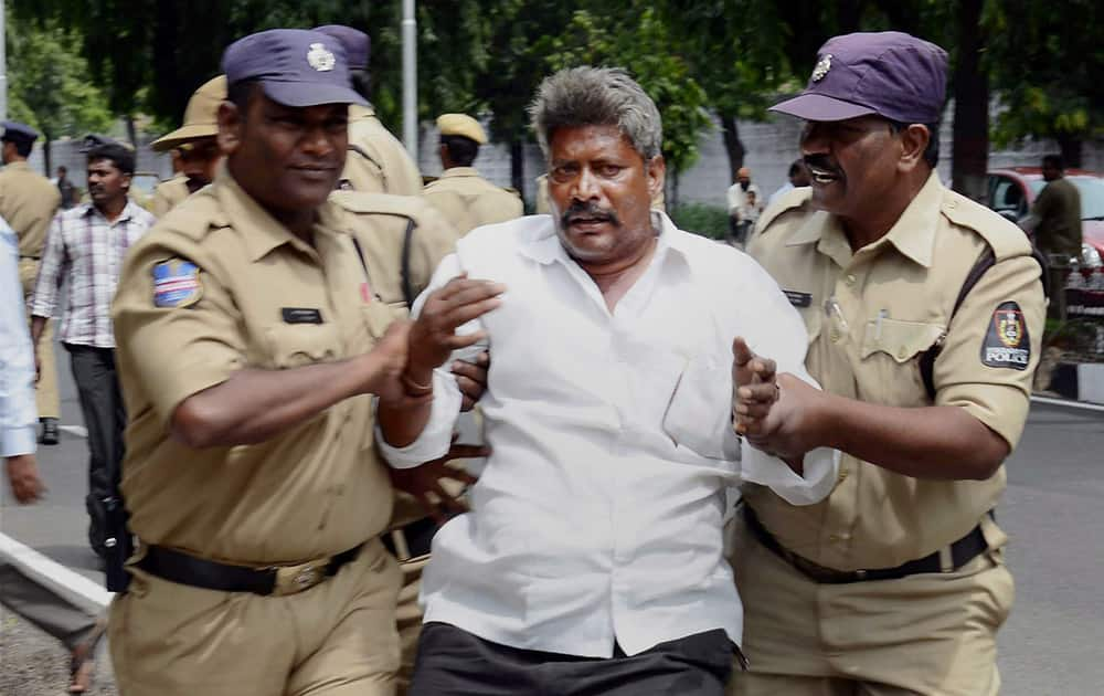 Police detains a farmer of Machavaram mandal in Guntur district for protesting against the government orders to cancel the mining lease of Saraswati Power Project, near AP CM Chandrababu Naidus camp office in Guntur.