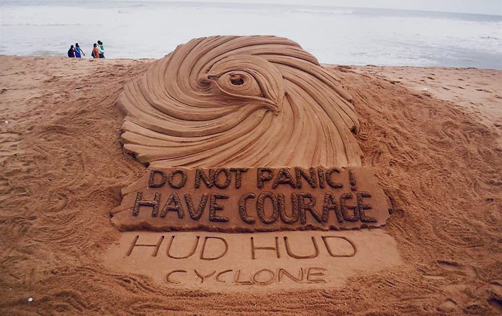 International sand artist Sudarsan Pattnaik craves a sand sculpture on cyclone Hudhud at a beach in Puri.