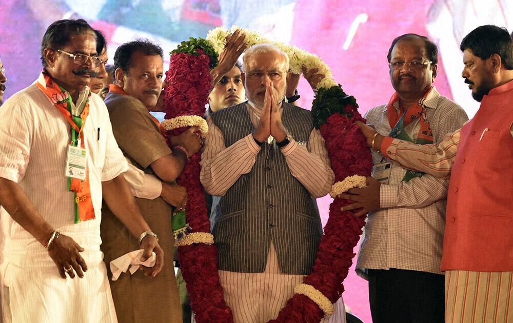 Prime Minister Narendra Modi is garlanded during an election campaign rally at Borivali in Mumbai.