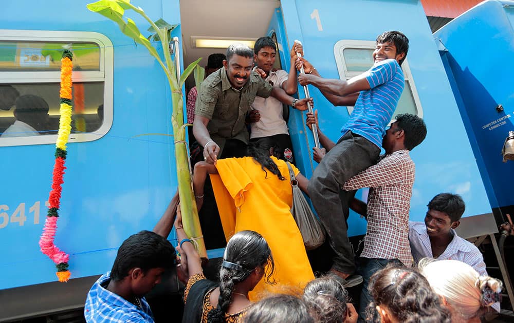 Sri Lankan ethnic Tamils board the `Queen of Jaffna` train decorated with banana plants and colorful flower garlands after it arrived at Jaffna in Sri Lanka.