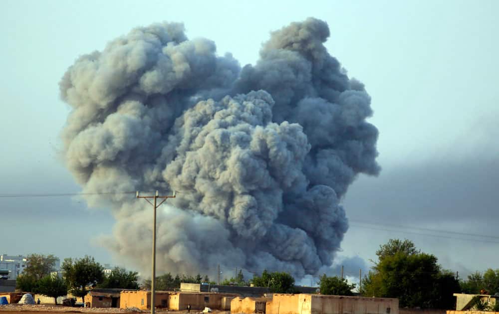 Thick smoke rises following an airstrike by the US-led coalition in Kobani, Syria as fighting continued between Syrian Kurds and the militants of Islamic State group, as seen from Mursitpinar on the outskirts of Suruc, at the Turkey-Syria border.