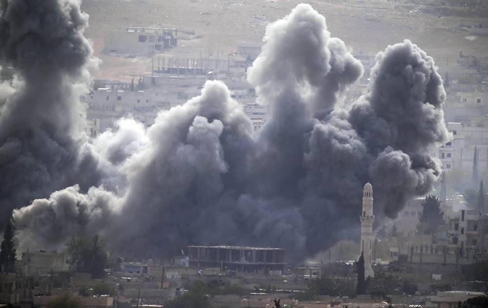 Thick smoke rises following an airstrike by the US-led coalition in Kobani, Syria as fighting continued between Syrian Kurds and the militants of Islamic State group, as seen from Mursitpinar on the outskirts of Suruc, at the Turkey-Syria border.