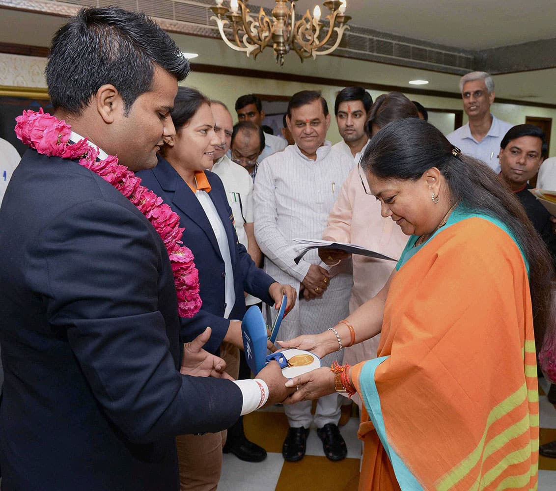 Rajasthan Chief Minister Vasundhara Raje felecitates Asian Games Gold Medal winning archer Rajat Chauhan in Jaipur.