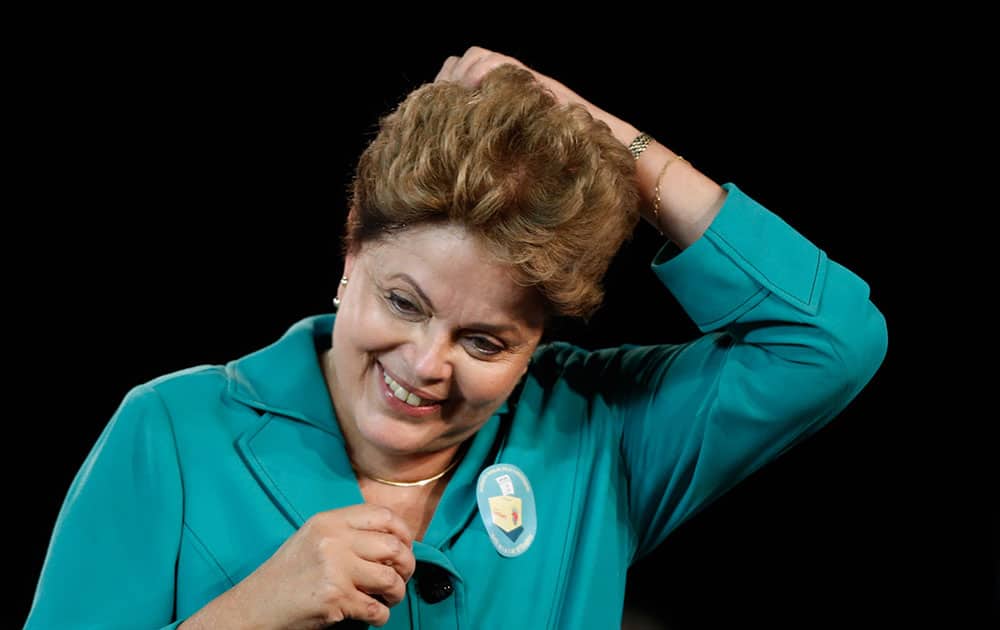 Brazil's President Dilma Rousseff, who is running for re-election with the Workers Party, PT, reacts during a campaign rally with social movements in Brasilia, Brazil.