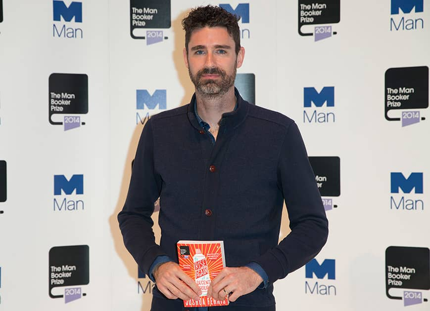 Man Booker prize 2014 nominee US author Joshua Ferris holds his book 'To Rise Again at a Decent Hour' during a photocall for the Man Booker Prize for fiction 2014 at the Royal Festival Hall in London.