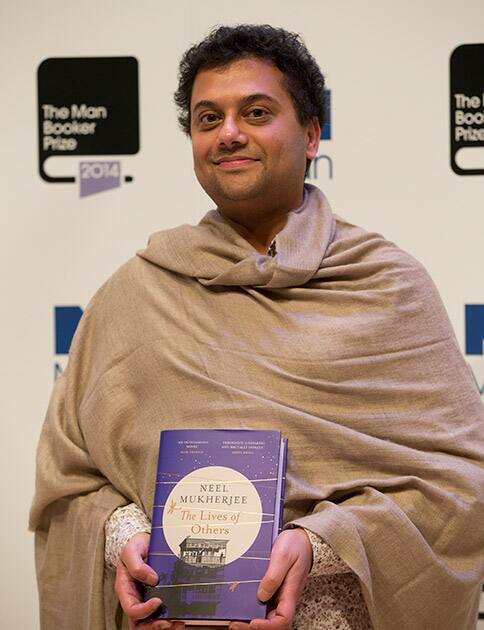 Man Booker prize 2014 nominee British author Neel Mukherjee holds his book 'The Lives of Others' during a photocall for the Man Booker Prize for fiction 2014 at the Royal Festival Hall in London.