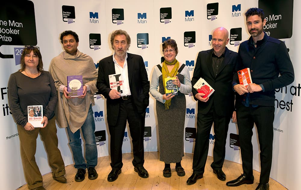 Nominees for the 2014 Man Booker prize for fiction, each holding their book from the left, British author Ali Smith, 'How To Be Both', British author Neel Mukherjee, 'The Lives of Others', British author Howard Jacobson 'J', US author Karen Joy Fowler, 'We Are All Completely Beside Ourselves', Australian author Richard Flanagan, 'The Narrow Road to the Deep North', and US author Joshua Ferris, 'To Rise Again at a Decent Hour', pose for the cameras during a photo call at the Royal Festival Hall in London.