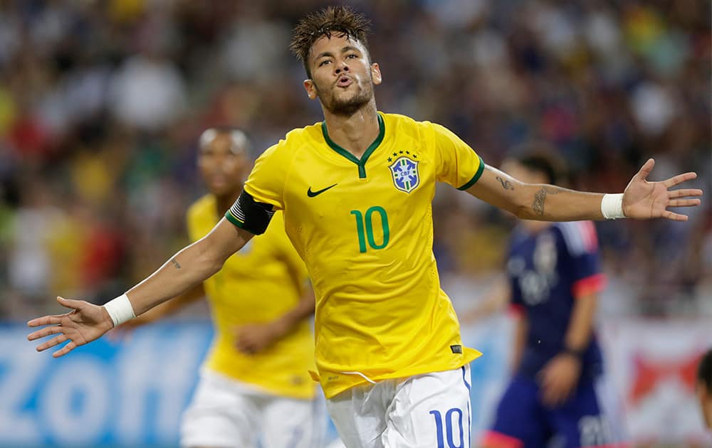 Brazil's Neymar celebrates after scoring his fourth goal against Japan during an international friendly soccer match in Singapore.