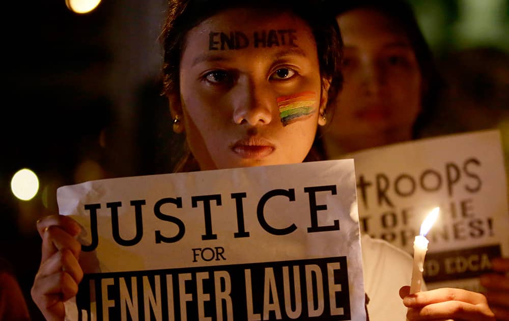 Protesters, mostly supporters of LGBT (Lesbians, Gays, Bisexuals and Transgenders), hold a lit candle and display messages to demand justice in the killing of a Filipino transgender Jeffrey 'Jennifer' Laude, with a US Marine as a possible suspect in Manila, Philippines.