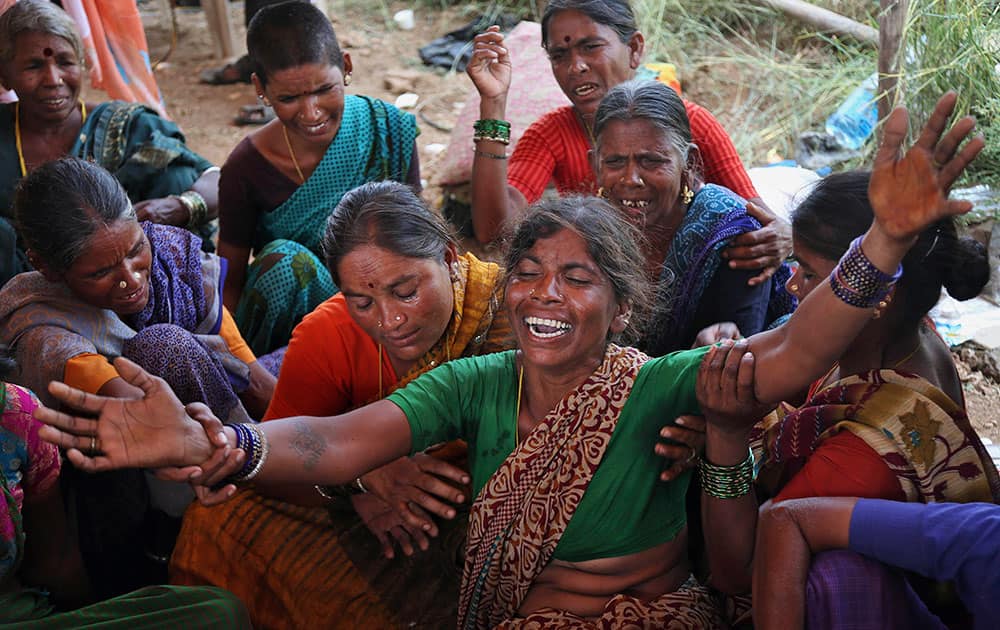 Ilamma, the grandmother of the four-years-old girl Girija who fell in an open borewell at an agricultural field, cries as National Disaster Response Force (NDRF) personnel search for her body at Manchala, in Ranga Reddy district.