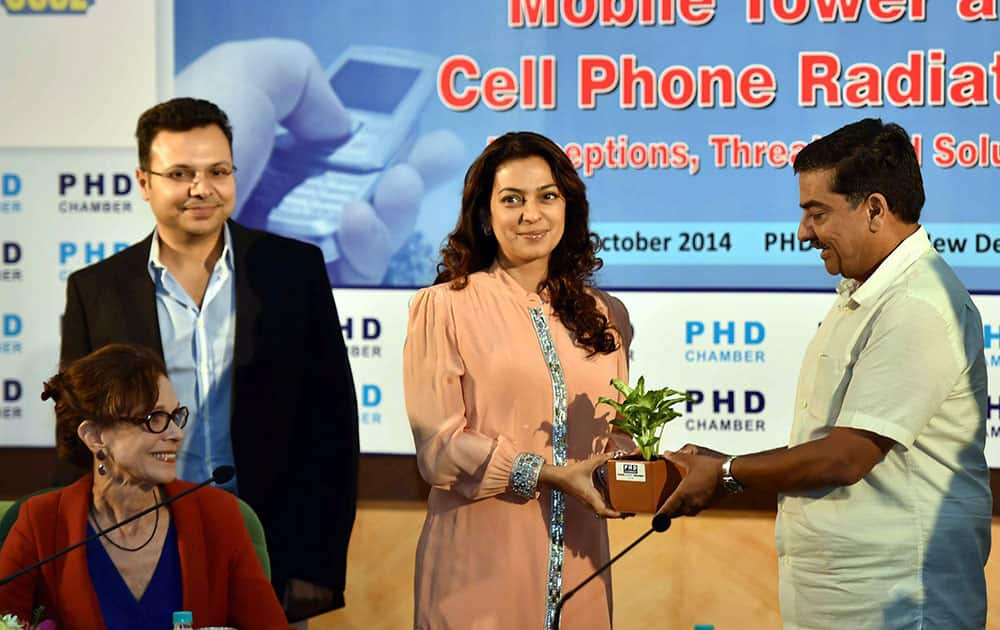 Juhi Chawla being gifted a sapling by Sr. Vice President of PHD Chamber Alok B Shriram during the Interactive Session on Mobile Tower and Cell Phone Radiations-Percepations,Threats and Solutions, in New Delhi.