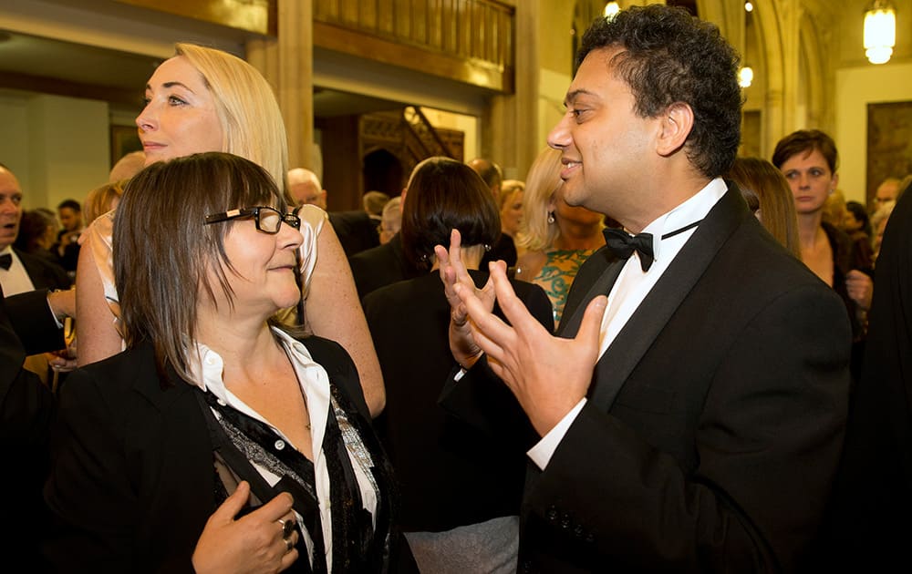 Two of the nominated authors British author Ali Smith, left, who wrote' How to be Both', and British author Neel Mukherjee, author of The Lives of Others', talk prior to the awards dinner for the Man Booker for fiction 2014 at the Guildhall in London.