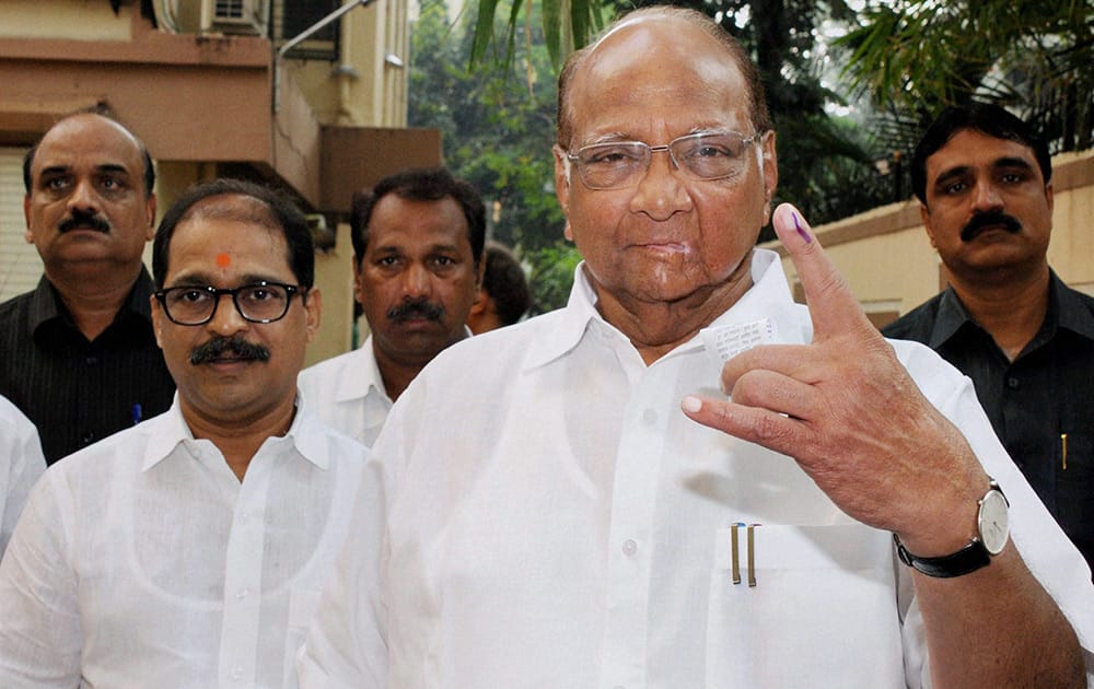 NCP chief Sharad Pawar shows his ink-marked finger after casting his vote for the Assembly elections at Tardeo in south Mumbai.