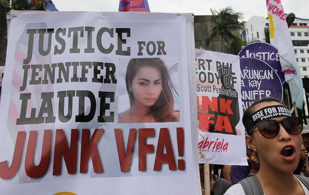 Protesters, mostly supporters of LGBT (Lesbians Gays Bisexuals and Transgenders) shout slogans during a rally at the Department of Foreign Affairs to demand justice for the killing of Filipino transgender Jeffrey 'Jennifer' Laude with a US Marine as a possible suspect, at suburban Pasay city, south of Manila, Philippines.