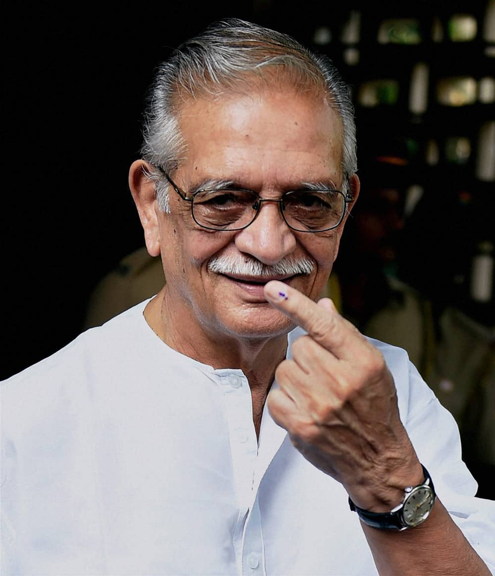 Lyricist Gulzar shows his inked finger after casting his vote for the Assembly elections in Mumbai.