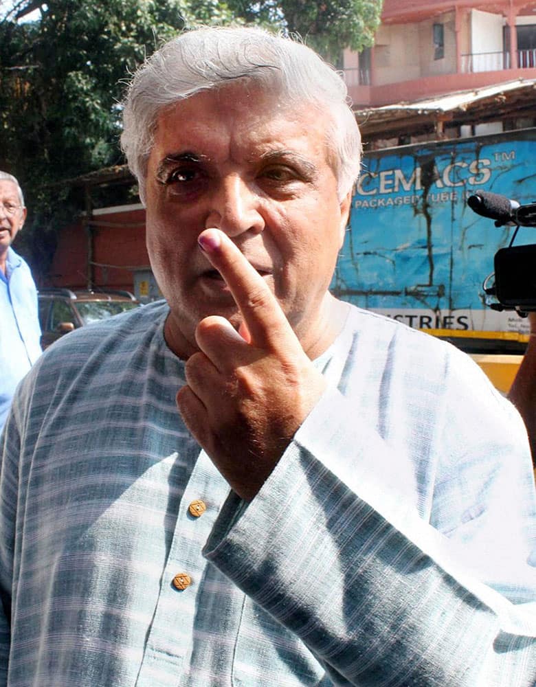  Lyricist Javed Akhtar shows his inked finger after casting his vote for the Assembly elections at a polling station in Mumbai on Wednesday. 