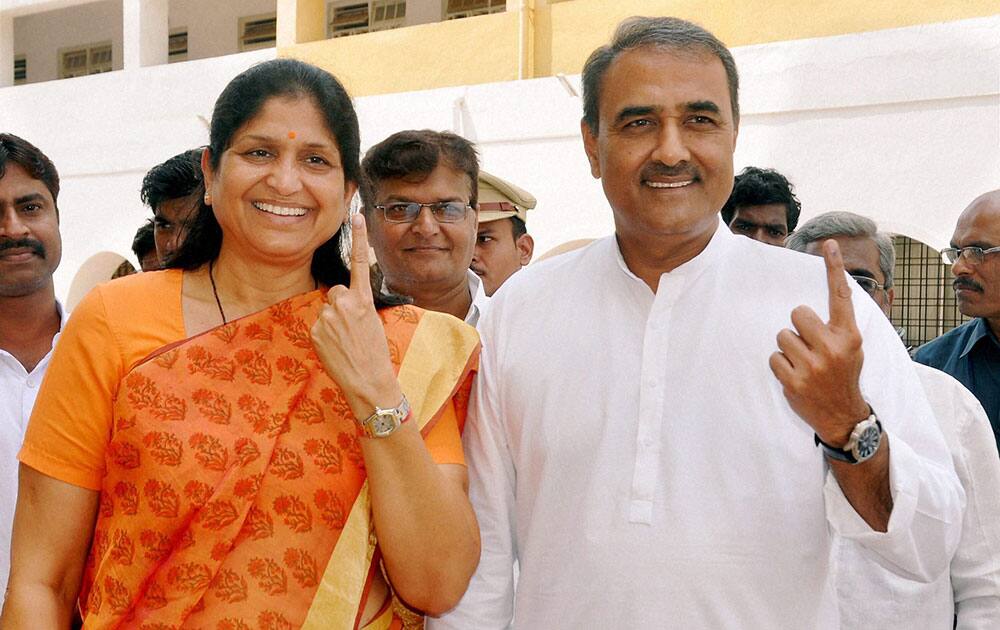 NCP leader Praful Patel along with wife showing their ink marked finger after casting votes at a polling booth during Assembly elections at Gondia on Wednsday. 