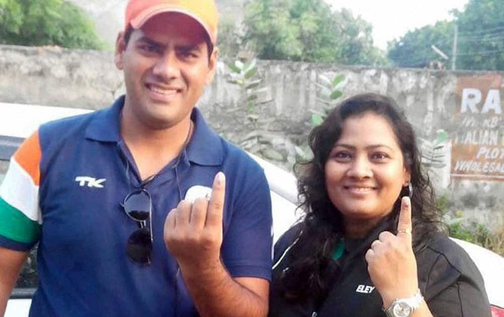 Shooter Anisha Sayyed with her husband after casting votes for Assembly elections in Faridabad on Wednesday.