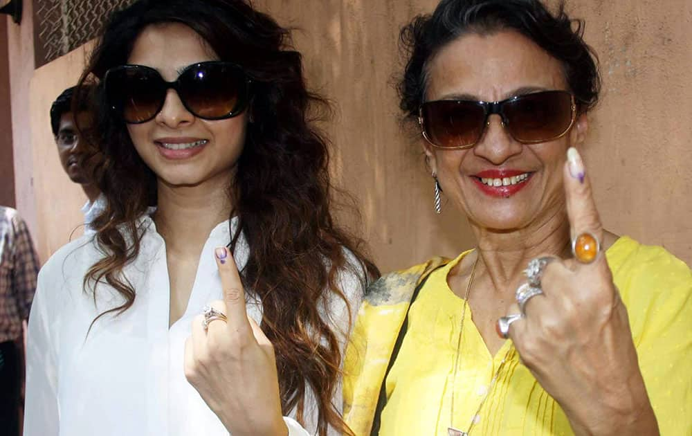 Actress Tanuja with her daughter Tanisha shows her inked finger after casting her vote for the Assembly elections in Mumbai on Wednesday.