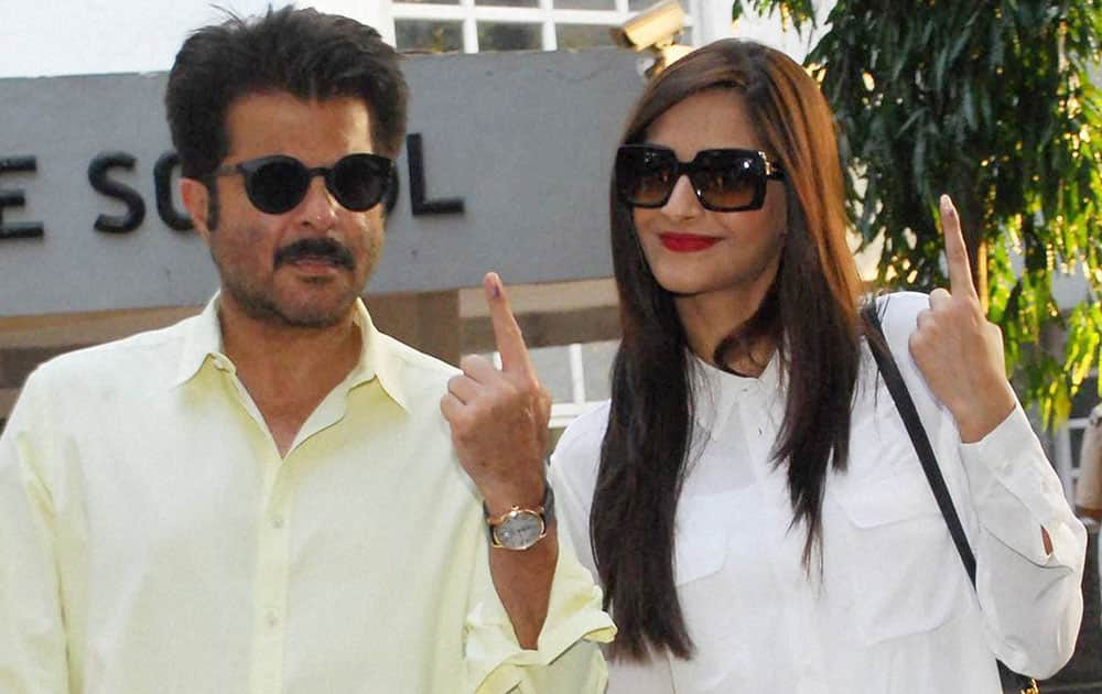 Bollywood actor Anil Kapoor with his daughter Sonam Kapoor after casting his vote for the Assembly elections, in Mumbai on Wednesday.