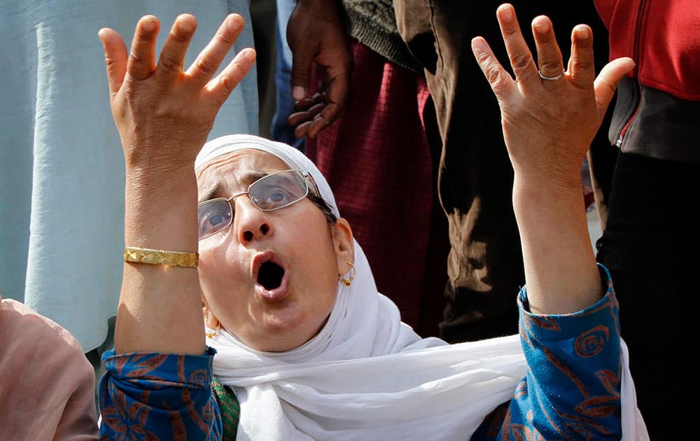 A Kashmiri woman blocks a road during a protest demanding rehabilitation of affected people in flooded areas, in Srinagar.