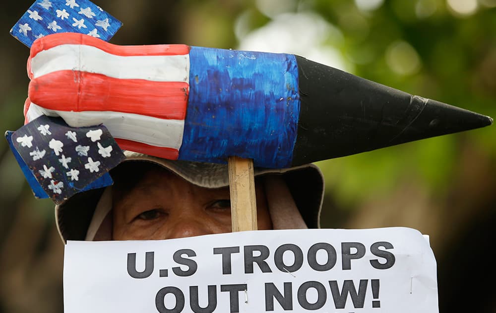 A protester holds a mock missile during a rally at the US Embassy in Manila to demand justice for the killing of Filipino transgender with a US Marine as a suspect in the Philippines.