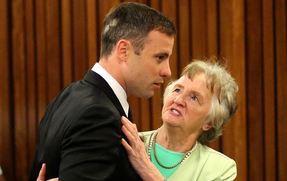 Oscar Pistorius is comforted by a supporter during the fourth day of sentencing proceedings in the high court in Pretoria, South Africa.