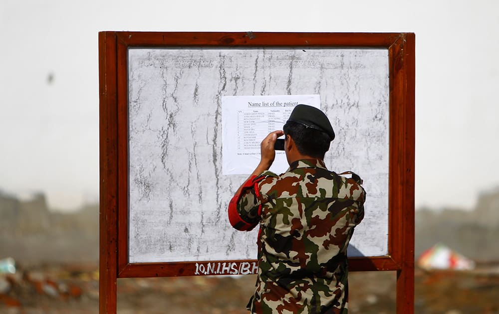 A Nepalese army soldier takes a photo of a patient’s list at the Army hospital in Katmandu, Nepal. At least 14 foreign trekkers have been rescued so far, including two from Hong Kong and 12 Israelis who were being treated at the Military Hospital in Katmandu. 