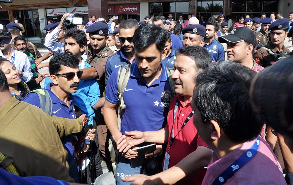 Mahendra Singh Dhoni, surrounded by his fans after his arrival at Kangra Airport for the One Day International Cricket match against West Indies in Dharamshala.