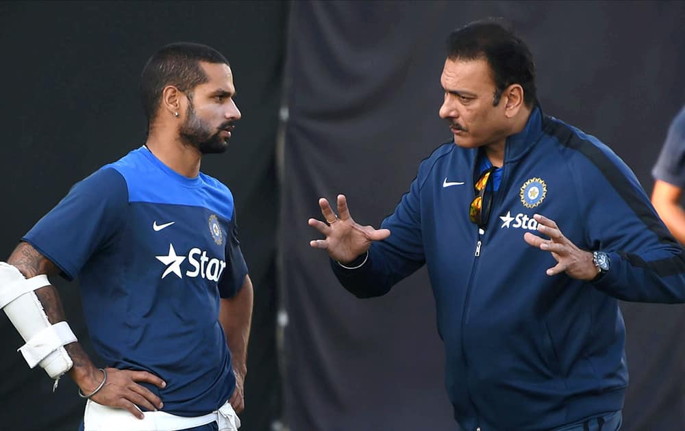 Team Indias director of cricket Ravi Shastri talks to Shikhar Dhawan during a practice session in Dharamshala ahead of the 4th ODI cricket match against West Indies.