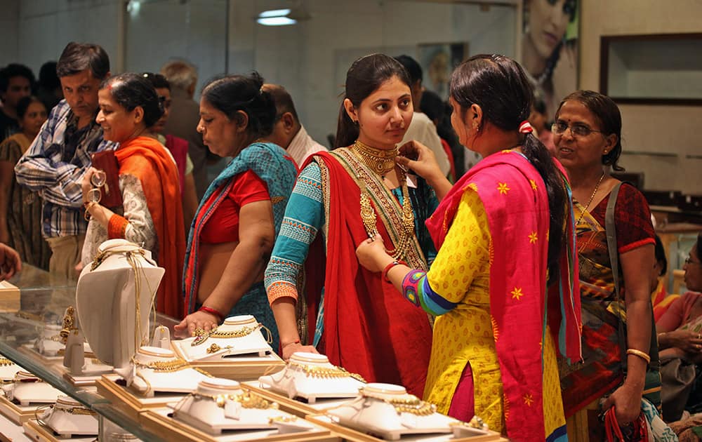 A girl tries a necklace on the occasion of 'Gurupushya Nakshatra' in Ahmadabad. Guru Pushya Nakshatra is considered an auspicious day for purchasing gold according to the Hindu calendar.