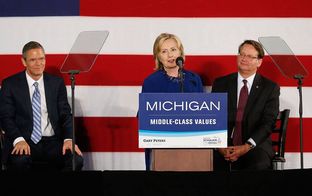 Former US Secretary of State Hillary Rodham Clinton speaks at a rally for gubernatorial candidate Mark Schauer and US Senate candidate Gary Peters, right, at Oakland University in Auburn Hills, Mich.