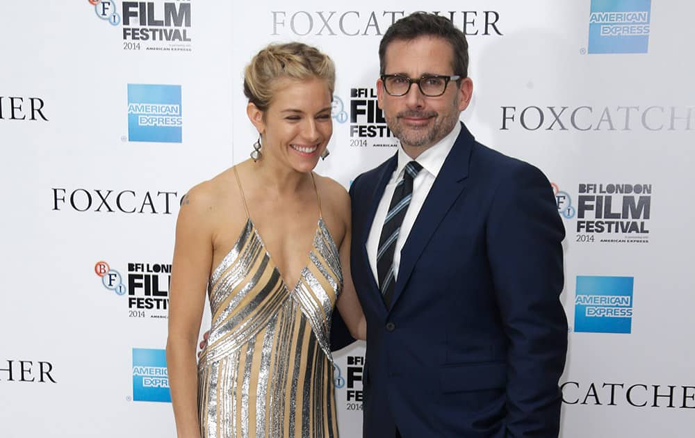 Actors Sienna Miller and Steve Carell pose for photographers upon arrival at the premiere of the film Foxcatcher, as part of the BFI London Film Festival, in central London.