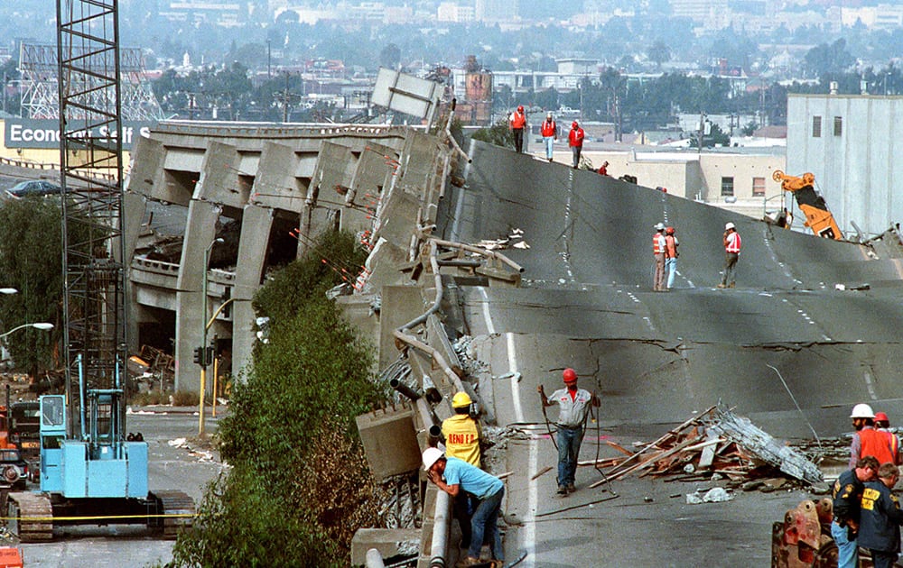 1989 file photo, workers check the damage to Interstate 880 in Oakland, Calif., after it collapsed during the Loma Prieta earthquake two days earlier. Friday is the 25th anniversary of the Loma Prieta earthquake that killed 63 people, injured almost 3,800 and caused up to $10 billion damage.