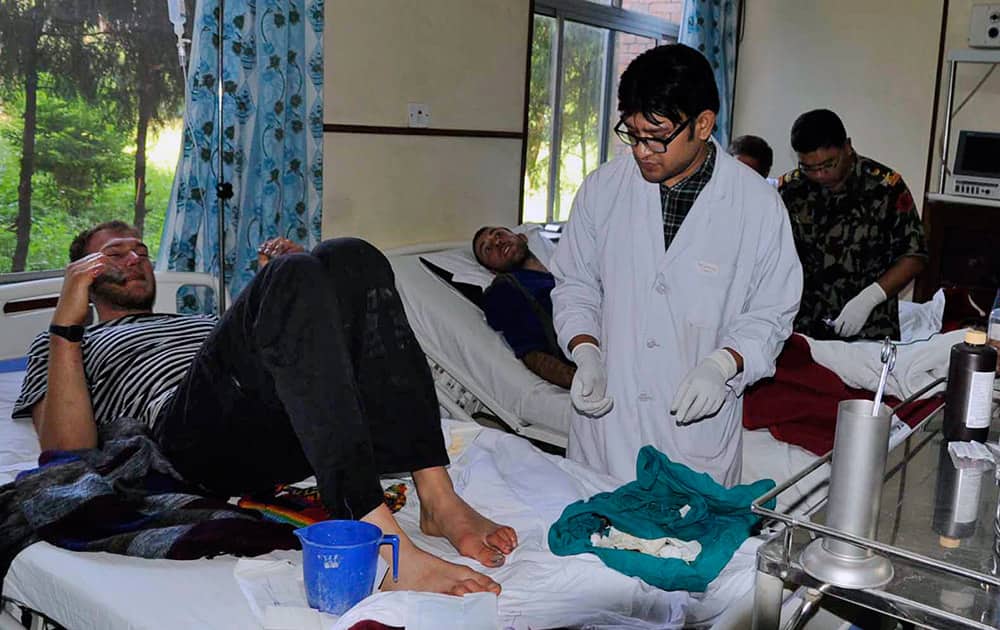 This photo released by Nepalese Army, unidentified survivors of an avalanche are treated at Army Hospital in Katmandu, Nepal. 