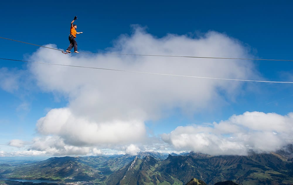 Guillaume Roland, a professional mountaineer, balances on the 'highline' during the European Highline Meeting on the top of the Moleson mountain at 2000 meters above the sea level, in the Swiss Alps, near Fribourg, Switzerland.